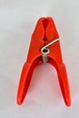 A beautiful red clothes peg with metallic spring Royalty Free Stock Photo