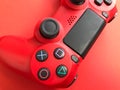 Beautiful red digital modern new game joystick for computer video games gamepad on a red background Royalty Free Stock Photo