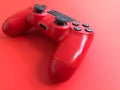 Beautiful red digital modern new game joystick for computer video games gamepad on a red background Royalty Free Stock Photo