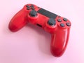 Beautiful red digital modern new game joystick for computer video games gamepad on a pink background Royalty Free Stock Photo