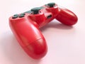 Beautiful red digital modern new game joystick for computer video games gamepad on a pink background Royalty Free Stock Photo