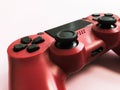 Beautiful red digital modern new game joystick for computer video games gamepad on a pink background Royalty Free Stock Photo