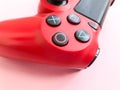 Beautiful red digital modern new game joystick for computer video games gamepad on a pink background Royalty Free Stock Photo