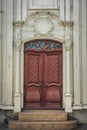 Beautiful red dual door with white pillars and vaulted top