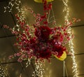 A beautiful red flower arrangement hanging from the roof