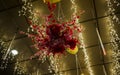 A beautiful red flower arrangement hanging from the roof