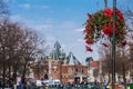 Beautiful red flowers embellish the bridges at the Old Central district in Amsterdam