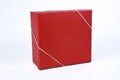 Beautiful red gift box with closed lid with side view and space for text on white background