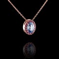 Beautiful red gold pendant with diamonds and sapphire, chain on a black background Royalty Free Stock Photo