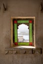 Beautiful red and gren stained glass window in the ancient city palace in Udaipur, India Royalty Free Stock Photo