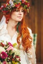 Beautiful red hair bride with flowers Royalty Free Stock Photo