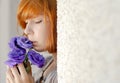 Beautiful red hair woman holding purple flower Royalty Free Stock Photo
