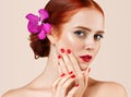 Beautiful red hair woman portrait with flower in hair perfect make up manicure Royalty Free Stock Photo