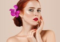 Beautiful red hair woman portrait with flower in hair perfect make up manicure Royalty Free Stock Photo