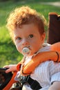 Beautiful red-haired boy in pram Royalty Free Stock Photo