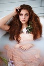 beautiful red-haired girl with beautiful . Natural beauty, natural hair color. Ginger, in a milk bath Royalty Free Stock Photo