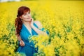 Beautiful girl in blue dress with yellow flowers Royalty Free Stock Photo