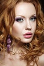 Beautiful red-haired girl with bright makeup and curls. Royalty Free Stock Photo