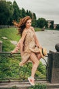 beautiful red-haired girl.picture against the background of the river, water, lake in the park, summer..sits on a fence, in the ha Royalty Free Stock Photo