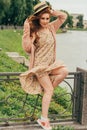 beautiful red-haired girl.picture against the background of the river, water, lake in the park, summer..the wind up the hem Royalty Free Stock Photo