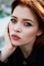 Beautiful red-haired girl with plump lips. Walking around the city. A natural beauty. Roof.Ginger