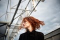 Beautiful red-haired girl with plump lips. Walking around the city. A natural beauty. Roof.Ginger