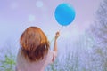 Woman in romantic mood with blue balloon