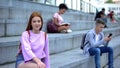 Beautiful red-haired teenager sitting stairs smiling camera, student exchange Royalty Free Stock Photo