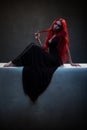 Beautiful red haired woman in black dress