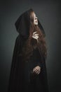 Beautiful red haired woman with black robe