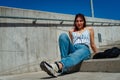 Beautiful red-haired young woman lying comfortably on a staircase outdoors Royalty Free Stock Photo