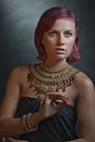 Beautiful red-haired young woman wearing a royal jewelry necklac