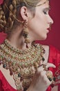 Beautiful red-haired young woman wearing a royal jewelry necklac