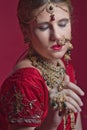 Beautiful red-haired young woman wearing a royal jewelry necklac