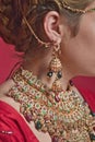 Beautiful red-haired young woman wearing a royal jewelry necklac