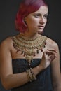Beautiful red-haired young woman wearing a royal jewelry necklac