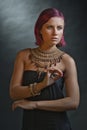 Beautiful red-haired young woman wearing a royal jewelry necklac