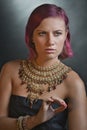 Beautiful red-haired young woman wearing a royal jewelry necklac
