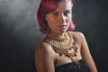 Beautiful red-haired young woman wearing a royal jewelry necklac