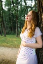 Redhead girl in deep woods posing near tree Royalty Free Stock Photo