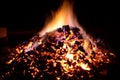 Beautiful red hot glowing ember pile with colorful flames Royalty Free Stock Photo