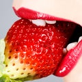 Beautiful red lips and tasty strawberry