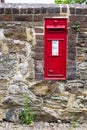 Beautiful red mailbox built into a stone wall