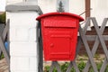 Beautiful red mailbox on grey fence outdoors Royalty Free Stock Photo