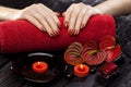 Beautiful red manicure with red calla flower and towel on the black wooden table. Royalty Free Stock Photo