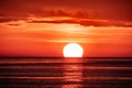 Beautiful red and orange sunset over the sea. The sun goes down over the sea. Two seagulls are flying against the sunset Royalty Free Stock Photo