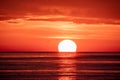 Beautiful red and orange sunset over the sea. The sun goes down over the sea. Two seagulls are flying against the sunset Royalty Free Stock Photo