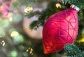 Beautiful red ornament on Christmas tree with sparkling white lights and soft background Royalty Free Stock Photo