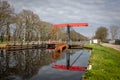 Beautiful red painted drawbridge with a nice water reflection Royalty Free Stock Photo