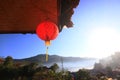 Beautiful red paper Chinese lanterns light hanging and decoration on eaves of Hill tribe wood house on the mountain in Thailand Royalty Free Stock Photo